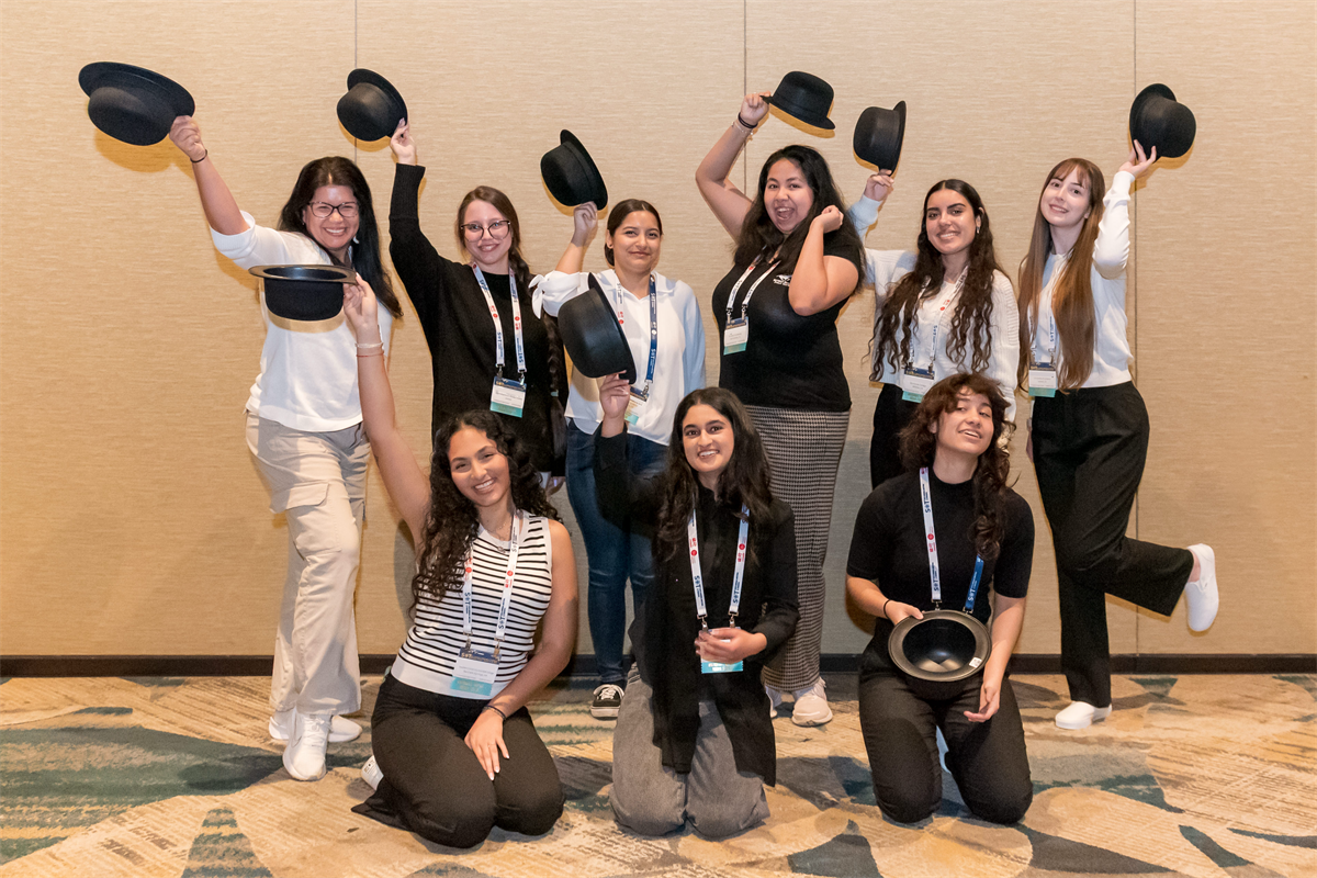 group of people with hats in their hands, smiling at the camera